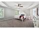 Large primary bedroom with neutral paint, tray ceiling and large windows at 3004 Westray Nw Ct, Marietta, GA 30064