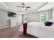 Spacious bedroom features a tray ceiling, TV, and large windows at 3004 Westray Nw Ct, Marietta, GA 30064