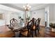 Spacious dining room with a large wooden table, hardwood floors, and modern chandelier at 3004 Westray Nw Ct, Marietta, GA 30064