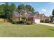 Well-maintained lawn, trees, and plantings accent the brick exterior of this suburban home at 3004 Westray Nw Ct, Marietta, GA 30064