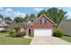 Charming brick home with an attached garage and a beautifully landscaped front yard at 3004 Westray Nw Ct, Marietta, GA 30064