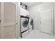 Efficient laundry room with washer, dryer, and storage cabinets at 3004 Westray Nw Ct, Marietta, GA 30064