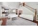 Open floor plan with white leather sofas, kitchen, and a staircase at 3004 Westray Nw Ct, Marietta, GA 30064