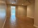 Finished basement featuring tiled floor, neutral colored walls, and doorway to outside at 43 Thornbush Ct, Hiram, GA 30141