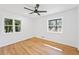 Light-filled bedroom with refinished hardwood floors and two windows, offering natural light and outdoor views at 4425 Cascade Sw Rd, Atlanta, GA 30331