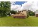 Lush backyard featuring a deck perfect for outdoor gatherings and entertaining guests at 5678 Fern Creek Sw Dr, Lilburn, GA 30047