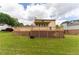 Backyard featuring lush green lawn, wooden deck, and mature trees providing shade at 5678 Fern Creek Sw Dr, Lilburn, GA 30047