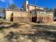 Large, fenced backyard featuring a spacious deck, perfect for outdoor entertaining at 5678 Fern Creek Sw Dr, Lilburn, GA 30047