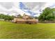 Expansive backyard with a well-maintained lawn, a deck, and mature trees at 5678 Fern Creek Sw Dr, Lilburn, GA 30047