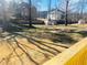Large backyard featuring two storage sheds, mature trees, and a bright green lawn at 5678 Fern Creek Sw Dr, Lilburn, GA 30047