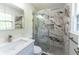 Updated bathroom featuring a glass-enclosed shower with modern tile and a quartz countertop vanity at 5678 Fern Creek Sw Dr, Lilburn, GA 30047