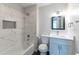Modern bathroom with updated shower, vanity and decorative mirror at 5678 Fern Creek Sw Dr, Lilburn, GA 30047