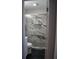 Stylish bathroom with a glass door shower and tile walls at 5678 Fern Creek Sw Dr, Lilburn, GA 30047