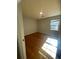 A bright bedroom with hardwood floors and a window at 5678 Fern Creek Sw Dr, Lilburn, GA 30047