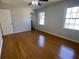 Bedroom with hardwood floors, neutral walls, and natural light at 5678 Fern Creek Sw Dr, Lilburn, GA 30047