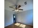 Bedroom with wood floors and standard ceiling fan at 5678 Fern Creek Sw Dr, Lilburn, GA 30047