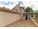 Back exterior view of home showing deck, siding, chimney, and sliding doors at 5678 Fern Creek Sw Dr, Lilburn, GA 30047