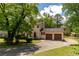 Beautiful two-story home with a two-car garage and a spacious driveway, surrounded by mature trees at 5678 Fern Creek Sw Dr, Lilburn, GA 30047
