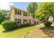 Charming two-story home with a well-manicured lawn and an attached two-car garage, plus red shutters at 5678 Fern Creek Sw Dr, Lilburn, GA 30047