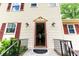 Home's inviting entrance, showing the front door, sidelights, and brick steps at 5678 Fern Creek Sw Dr, Lilburn, GA 30047