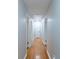 Hallway featuring wood floors and crisp neutral paint at 5678 Fern Creek Sw Dr, Lilburn, GA 30047