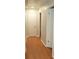Hallway with wood flooring, doors and neutral colored walls at 5678 Fern Creek Sw Dr, Lilburn, GA 30047