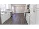 Modern kitchen with white cabinets, stainless steel appliances, updated countertops, and stylish pendant lighting at 5678 Fern Creek Sw Dr, Lilburn, GA 30047