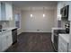 Well-lit kitchen area with stainless steel appliances and modern white cabinetry at 5678 Fern Creek Sw Dr, Lilburn, GA 30047