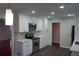 Modern kitchen featuring white cabinets, stainless steel appliances, and elegant countertops at 5678 Fern Creek Sw Dr, Lilburn, GA 30047