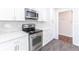 Close up of range, counter top and microwave, shows stainless steel appliances in newly updated kitchen at 5678 Fern Creek Sw Dr, Lilburn, GA 30047