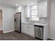 Updated kitchen showcasing stainless steel refrigerator, cabinets, and updated counter tops at 5678 Fern Creek Sw Dr, Lilburn, GA 30047