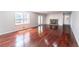 Bright living room with a fireplace and gleaming hardwood floors at 5678 Fern Creek Sw Dr, Lilburn, GA 30047