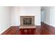 Living room featuring a brick fireplace with a white mantel and hardwood floors at 5678 Fern Creek Sw Dr, Lilburn, GA 30047