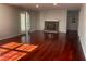 Spacious living room with hardwood floors and a classic brick fireplace at 5678 Fern Creek Sw Dr, Lilburn, GA 30047
