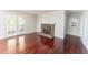 Open-concept living room with hardwood floors and fireplace at 5678 Fern Creek Sw Dr, Lilburn, GA 30047