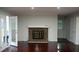 Cozy living room with a classic brick fireplace and sliding doors to the outdoors at 5678 Fern Creek Sw Dr, Lilburn, GA 30047