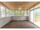 Bright sunroom featuring a wood ceiling, multiple windows, and carpeted floor at 5678 Fern Creek Sw Dr, Lilburn, GA 30047