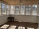 Bright sunroom featuring wood-paneled ceiling and large picture windows at 5678 Fern Creek Sw Dr, Lilburn, GA 30047