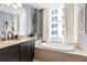 Well-lit bathroom showcases a soaking tub, vanity with granite countertop, and modern decor at 57 Forsyth Nw St # 5F, Atlanta, GA 30303