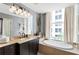 Contemporary bathroom offers a soaking tub with a large window, and a vanity with designer fixtures at 57 Forsyth Nw St # 5F, Atlanta, GA 30303