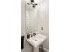 Powder room with black fixtures, dark flooring, and pedestal sink at 57 Forsyth Nw St # 5F, Atlanta, GA 30303
