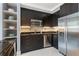 Well-equipped kitchen with black cabinets, stainless steel appliances, and open shelving at 57 Forsyth Nw St # 5F, Atlanta, GA 30303