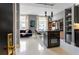 Modern kitchen area featuring sleek white floors, stylish cabinetry and a view of the living room at 57 Forsyth Nw St # 5F, Atlanta, GA 30303