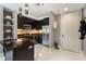 Modern kitchen featuring black cabinets, stainless steel appliances, and an island with a cooktop at 57 Forsyth Nw St # 5F, Atlanta, GA 30303