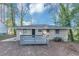 Backyard view of home featuring a grey wooden fence, painted brick, and black front door at 1834 Hillsdale Dr, Decatur, GA 30032