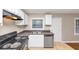 This kitchen offers white cabinetry, a stainless steel dishwasher, and a window over the sink at 1834 Hillsdale Dr, Decatur, GA 30032