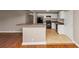 Open-concept kitchen features a breakfast bar, black appliances, and neutral tile flooring at 1834 Hillsdale Dr, Decatur, GA 30032