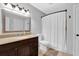 Well-appointed bathroom featuring a granite vanity top, a decorative mirror, and a shower at 305 Mill Pond Se Ct, Smyrna, GA 30082