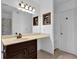 Bright bathroom with a sleek vanity, well-lit mirror, and convenient built-in shelving at 305 Mill Pond Se Ct, Smyrna, GA 30082