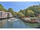 Scenic view of the community pool area with lush landscaping, water feature, and surrounding residential buildings at 305 Mill Pond Se Ct, Smyrna, GA 30082